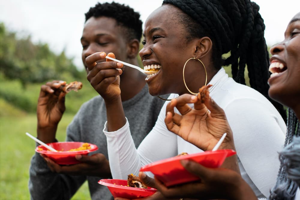 People enjoying Nigerian cuisine together